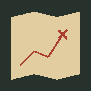 A paper map with a red route ending at an X
